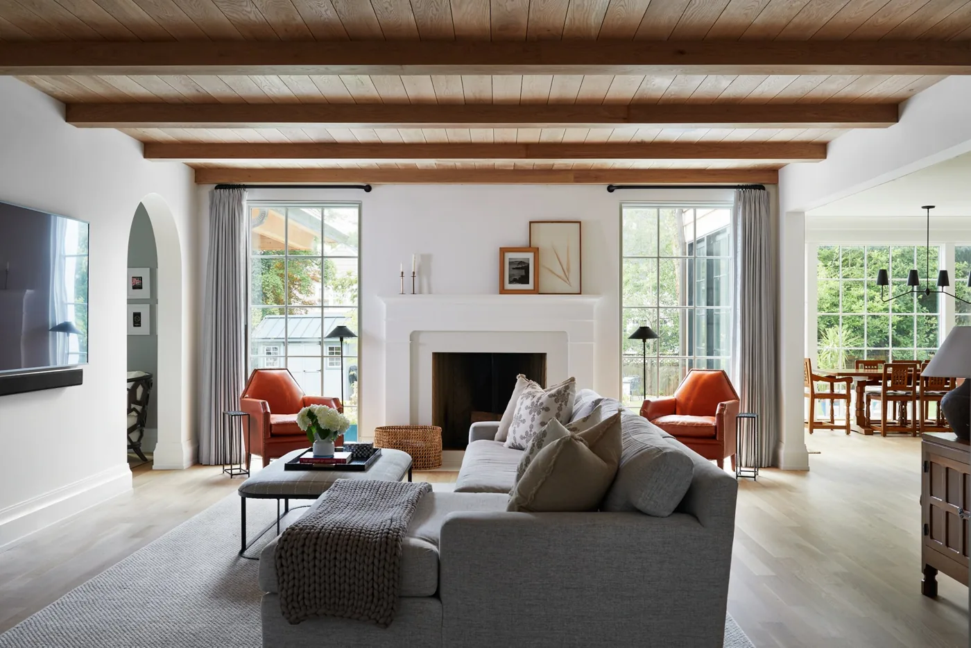 Casacquasanta family room with a wood-plank ceiling, beams, neutral seating and a white fireplace in Westfield, NJ